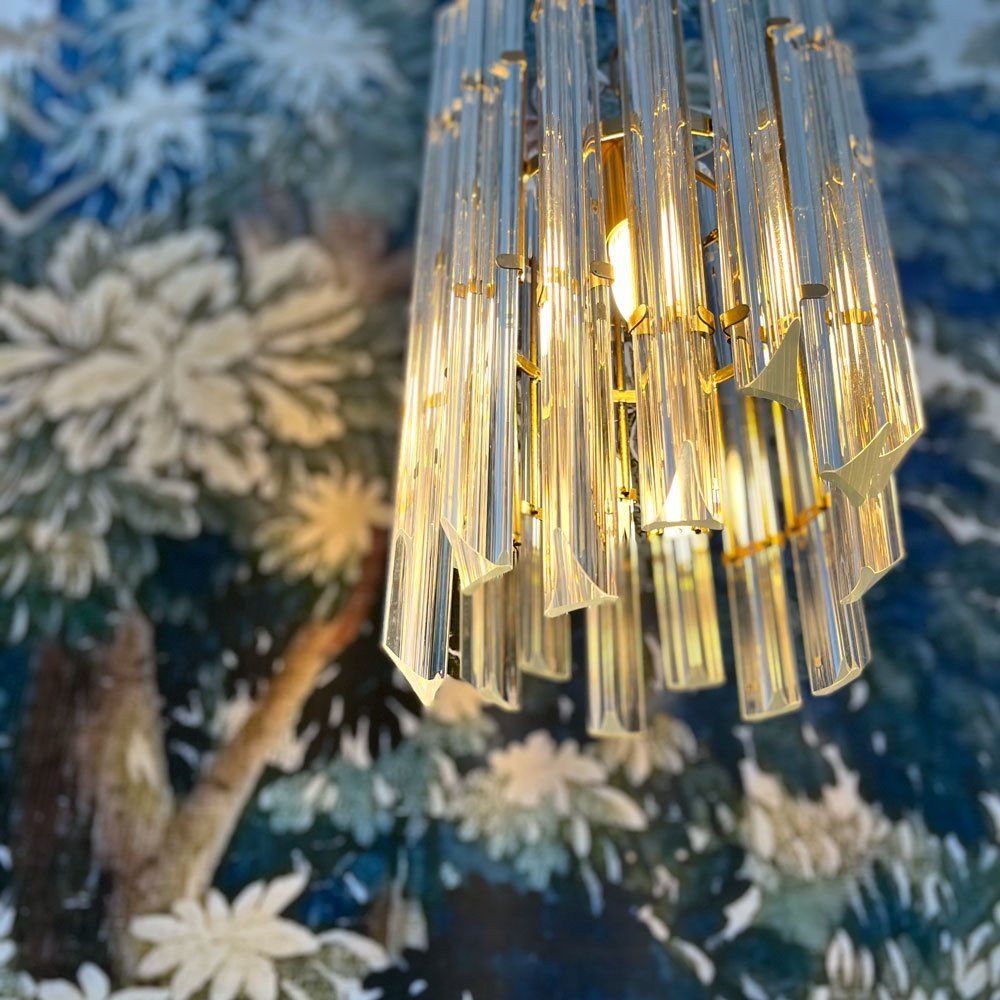 Crystal Light fixture in front of bold wallpaper installed by Hue and Space Interior Design