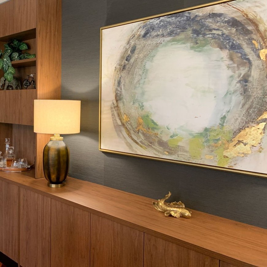 Large art canvas by @designerboysart mounted above custom walnut timber joinery designed by Hue and Space Interior Design