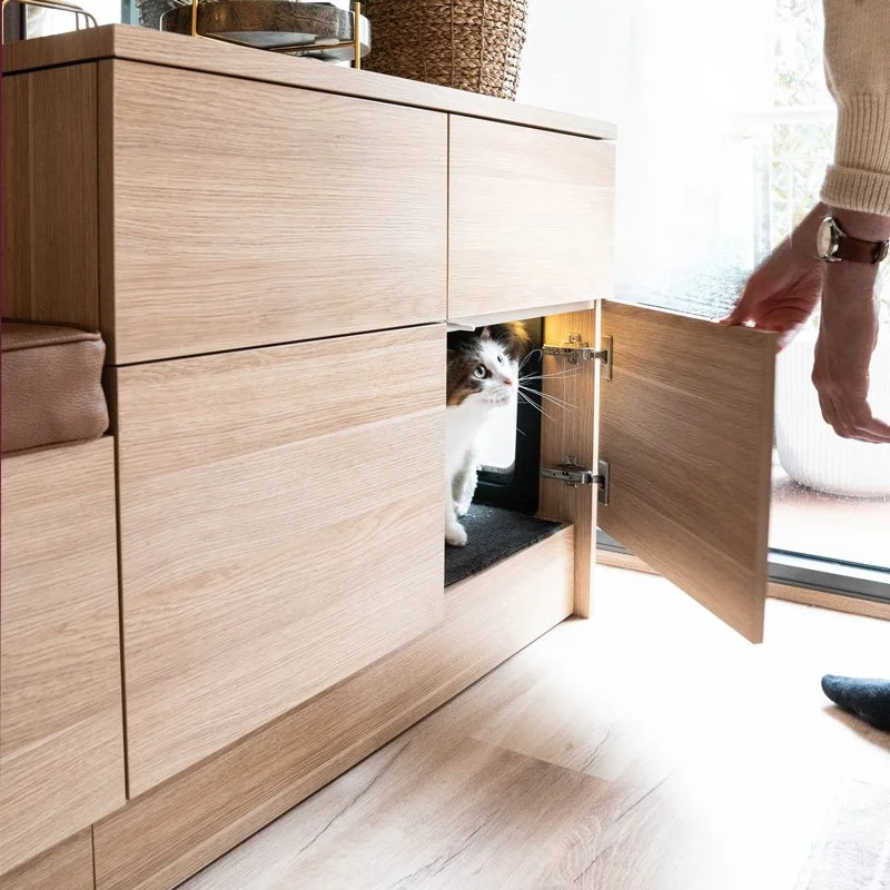 Door of joinery opening to show the cat and his litter tray
