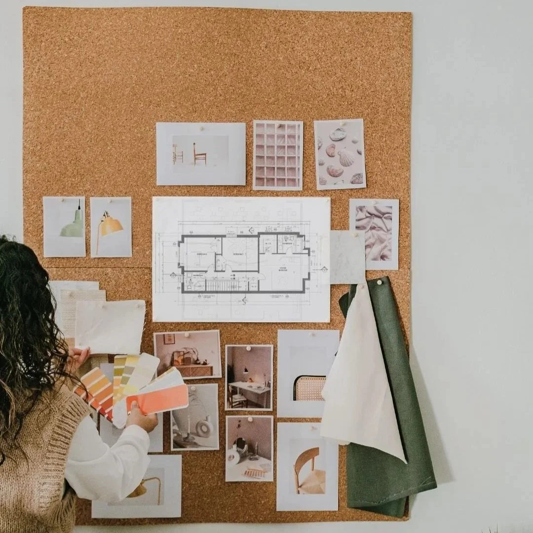 Designer pinning colour swatches to a board with a floor plan and funriture examples