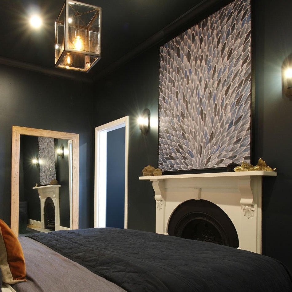 Boys bedroom showing fireplace, large art canvas and timber framed mirror designed by Hue and Space Interior Design