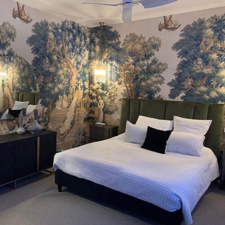 Bold primary bedroom design with black accents and wallpaper designed by Hue and Space Interior Design