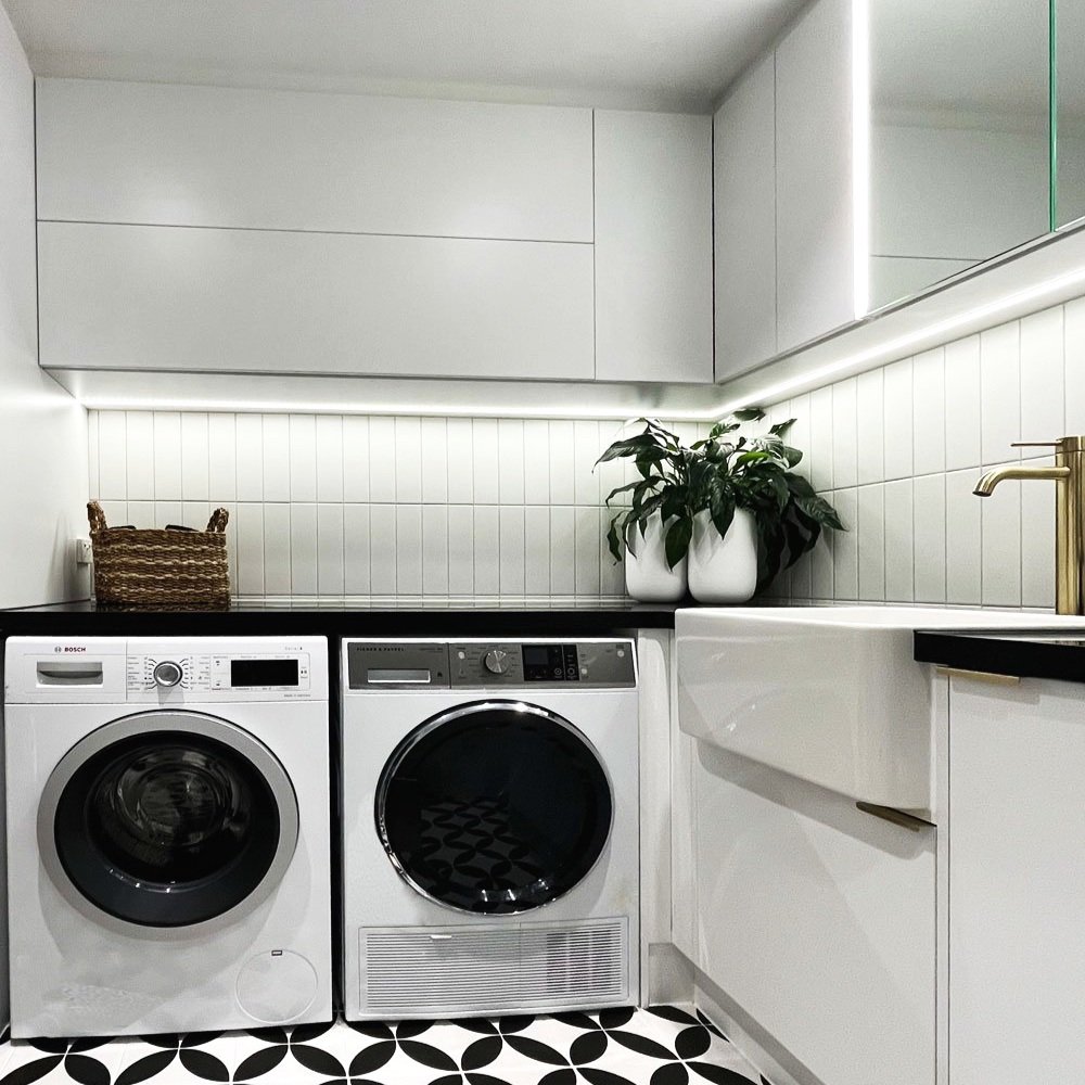 Black and white bathroom with under cabinet LED lighting designed by Hue and Space Interior Design
