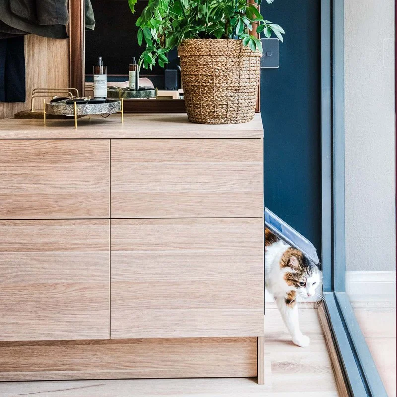 Cat exiting hidden kitty litter built into joinery