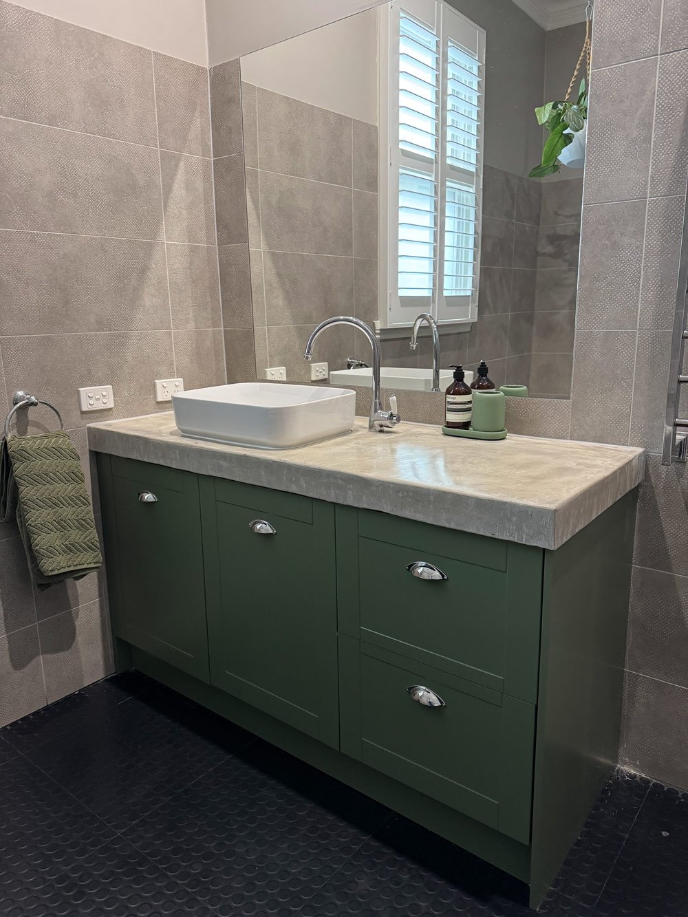 green bathroom with grey tiles