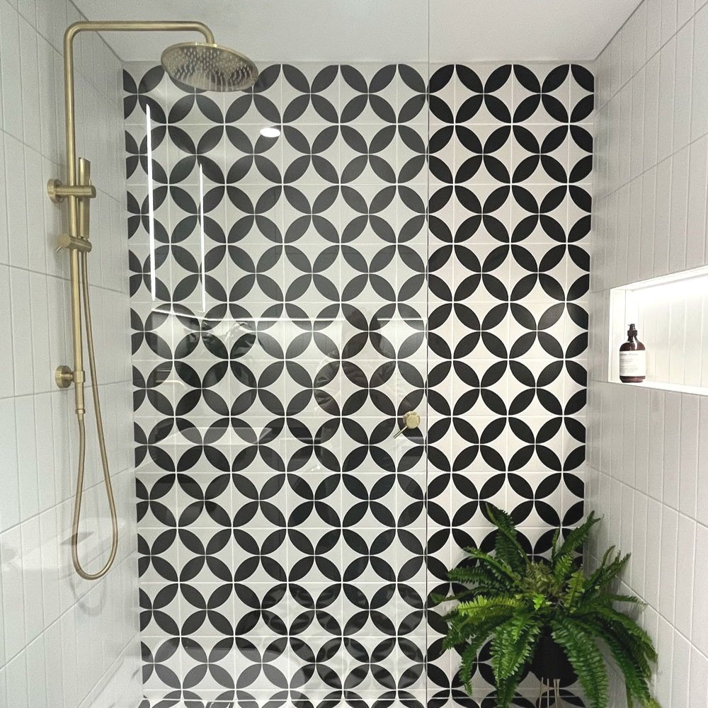 Black and white geometric tile in show with brass fittings designed by Hue and Space Interior Design
