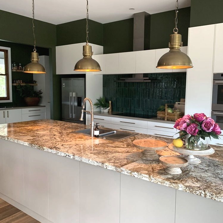 Hue and Spaxe designed kitchen with large brass pendant lights, green tile and granite benchtop