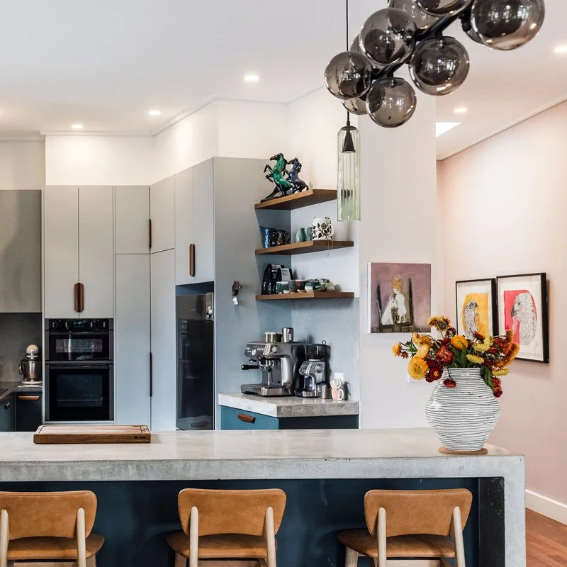 Leather stools at a concrete kitchen bench