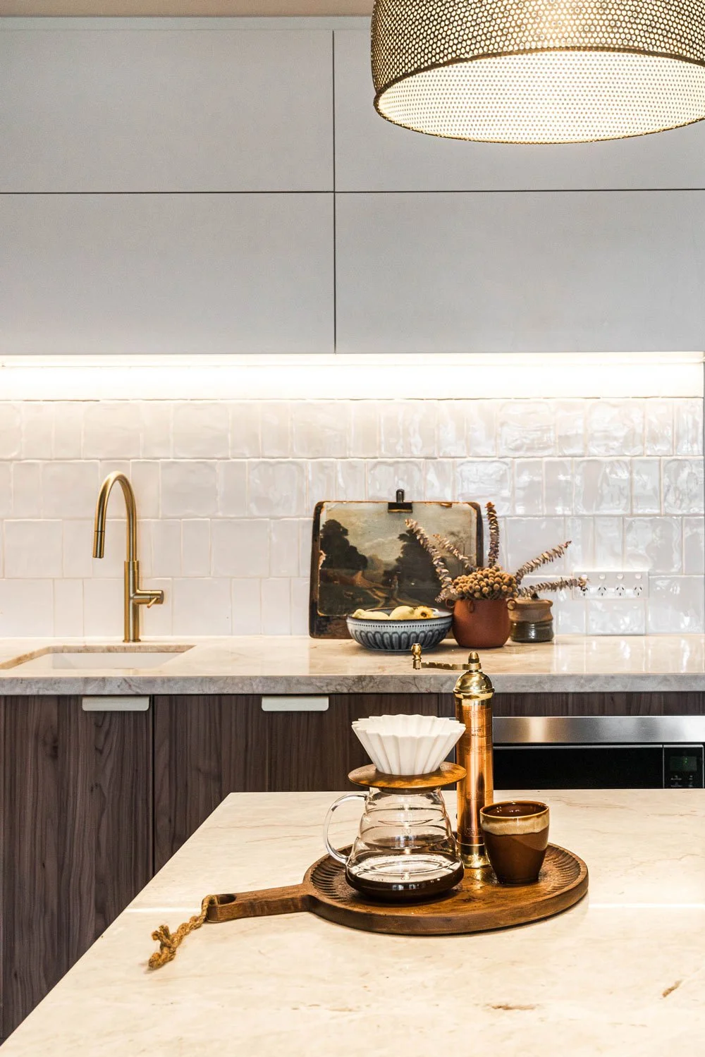 kitchen with handmade white tiles stone counter and coffee drip filter on the bencg