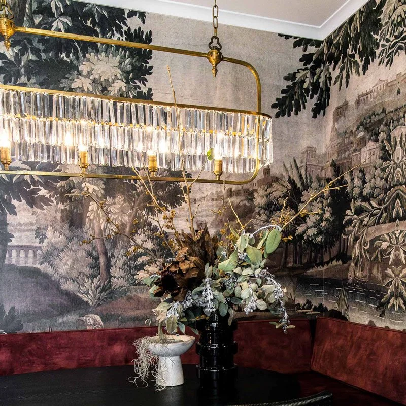 Crystal Chandelier in dining room with bold wallpaper