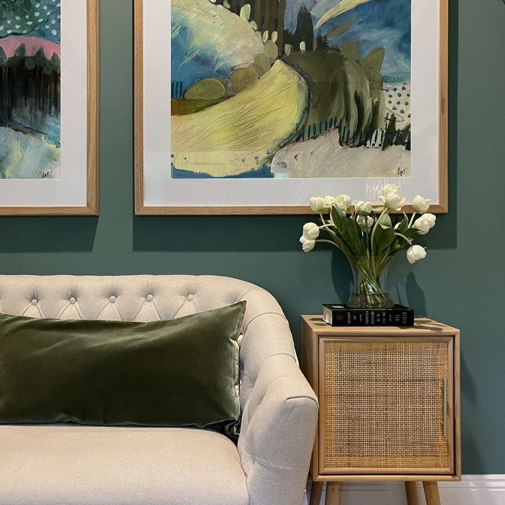 Sofa next to rattan side table with colourful art in teenage girls bedroom designed by Hue and Space Interior Design