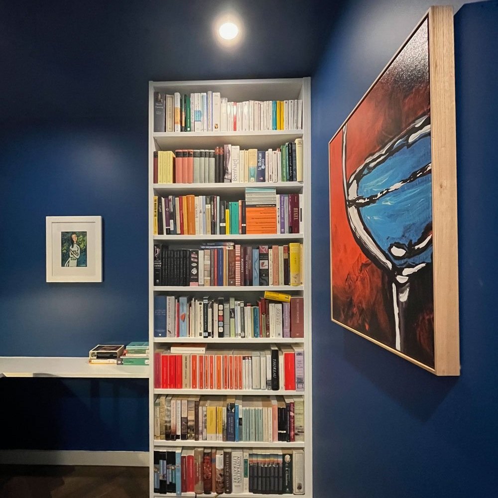 Bright blue walls in a window-less home office, orignally on the plans as a second bathroom