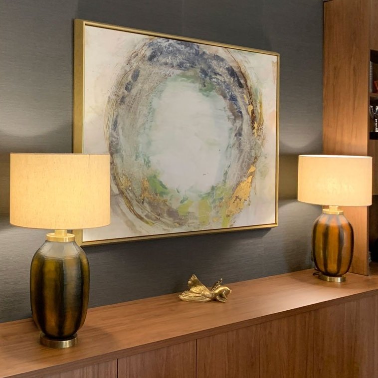 Custom joinery with abstract artwork and twin amber base lamps, home office design by Hue and Space Interior Design