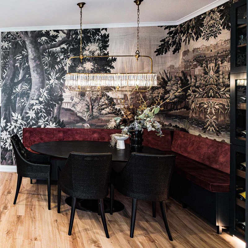 Bold wallpaper, velvet banquette in blues and maroons