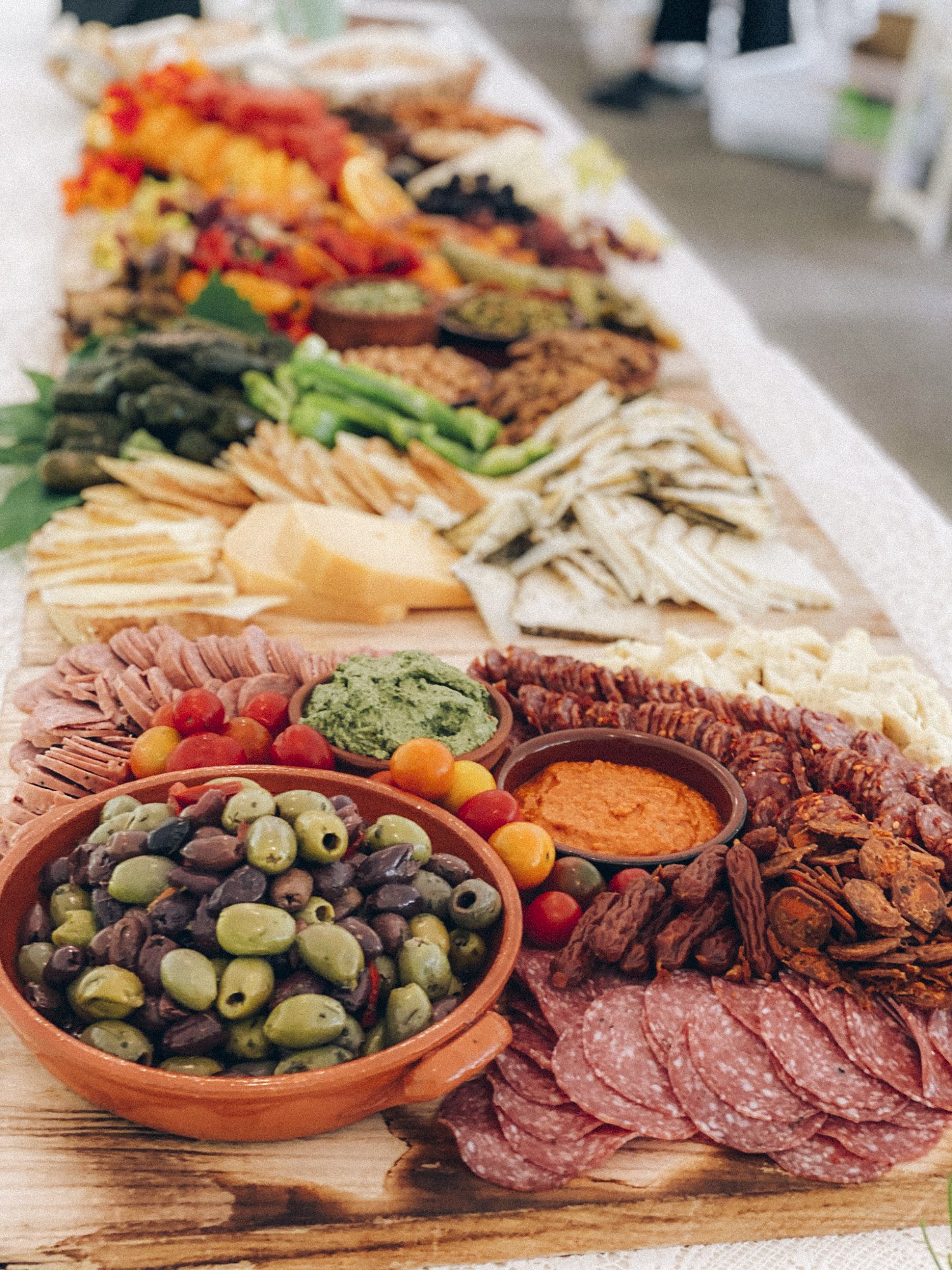 grazing board full of olives charcuterie cheeses fruits and nuts for wedding in oregon