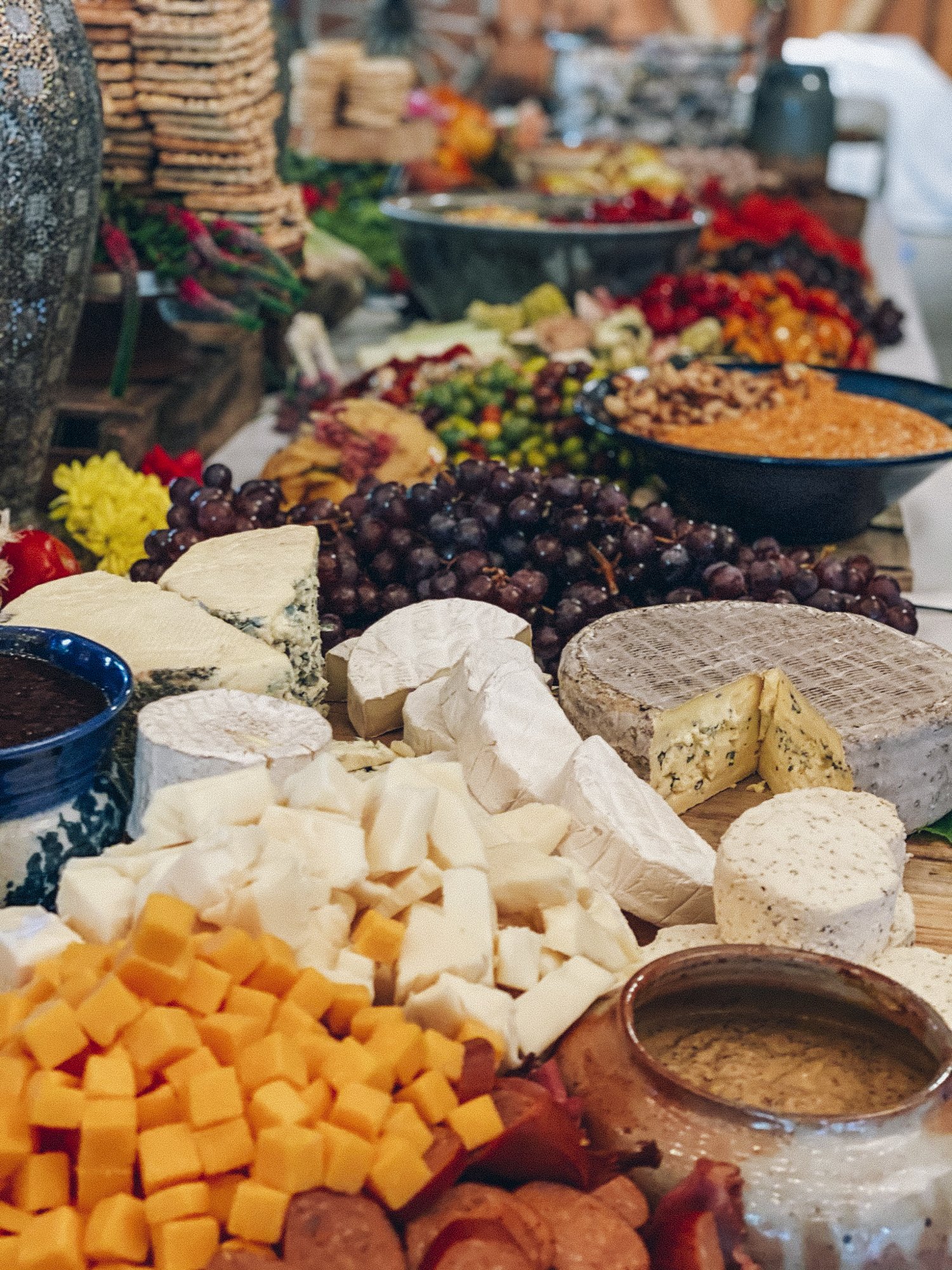 large grazing board for large wedding with charcuterie and cheese and accoutrements 
