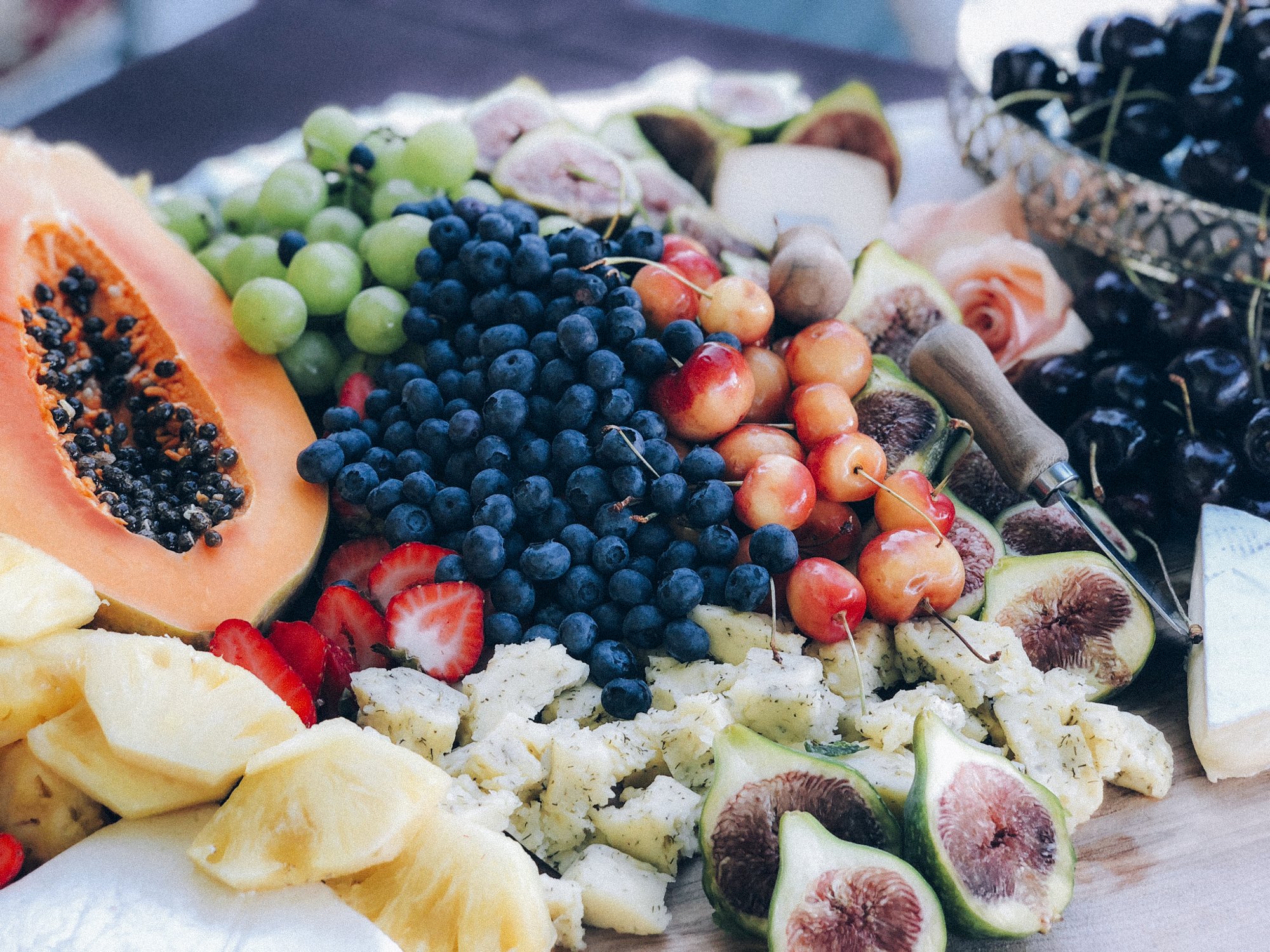 fruit platter with papaya figs blueberries cherries and grapes 