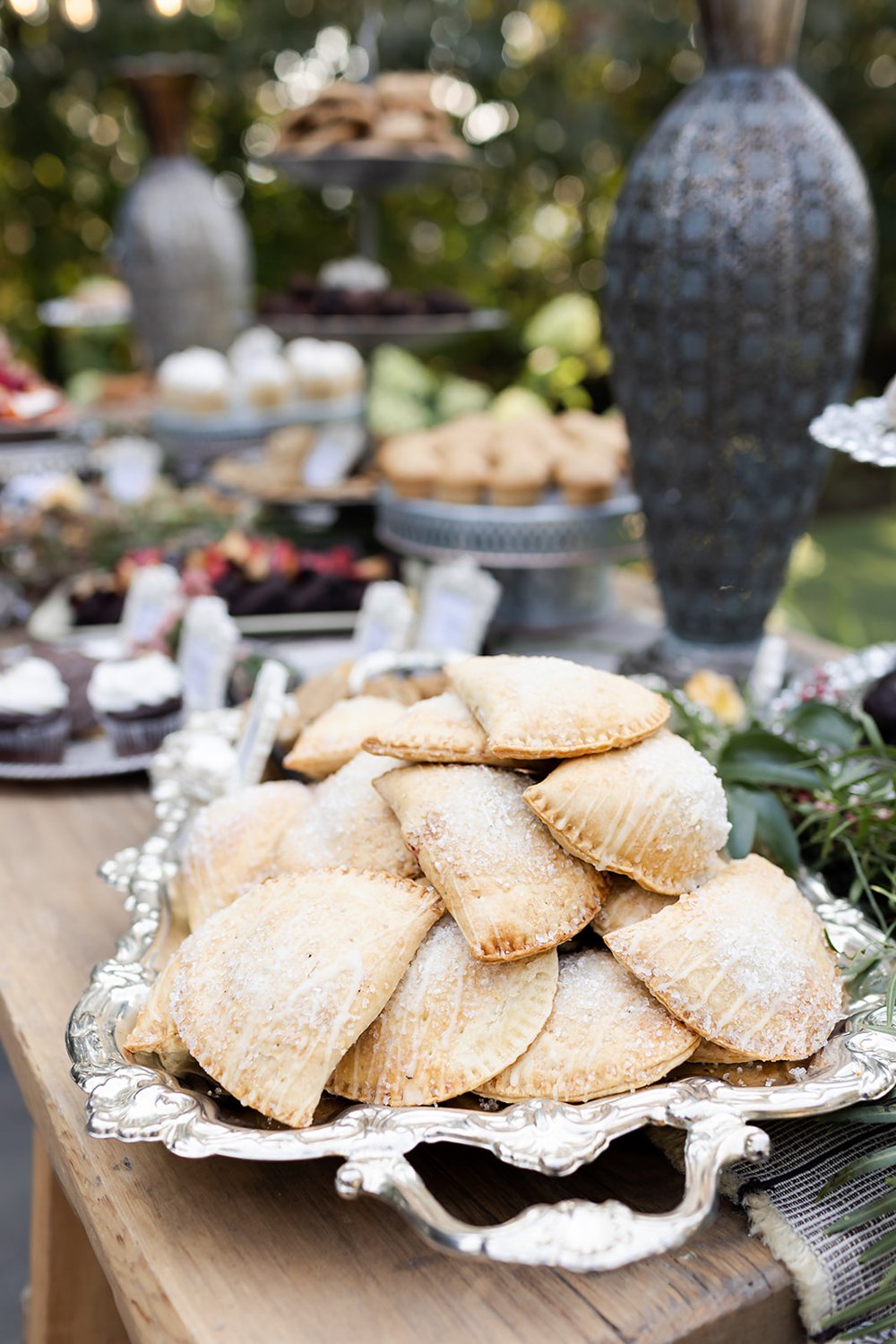 hand pies with drizzled frosting on wedding dessert bar