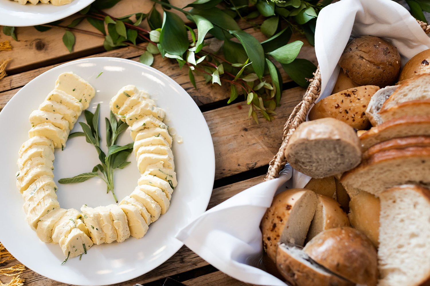 sliced artisan bread basket with herbed butter medallions 