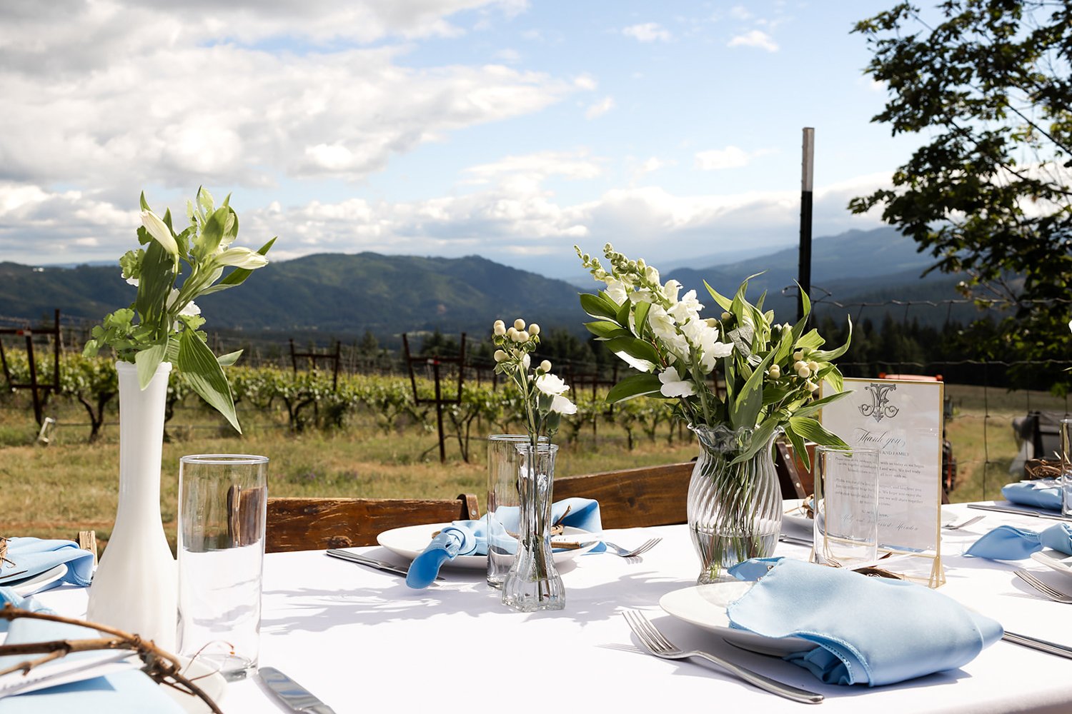 blue and white rose table setting at outdoor wedding in oregon