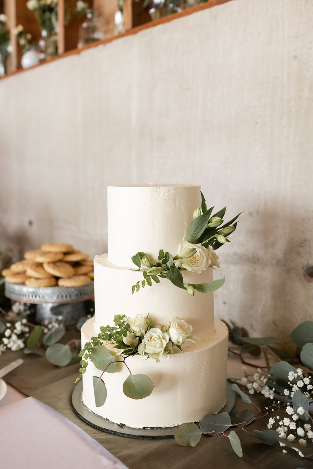 simple elegant white wedding cake with floral details