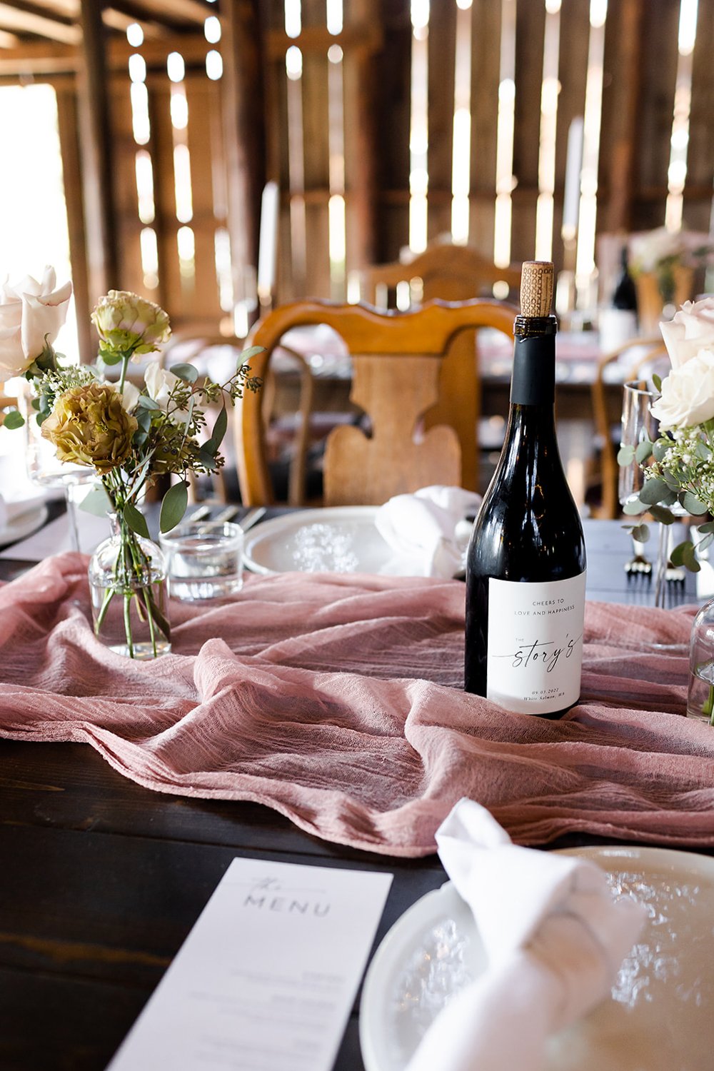 pink and white wedding table settings with wine