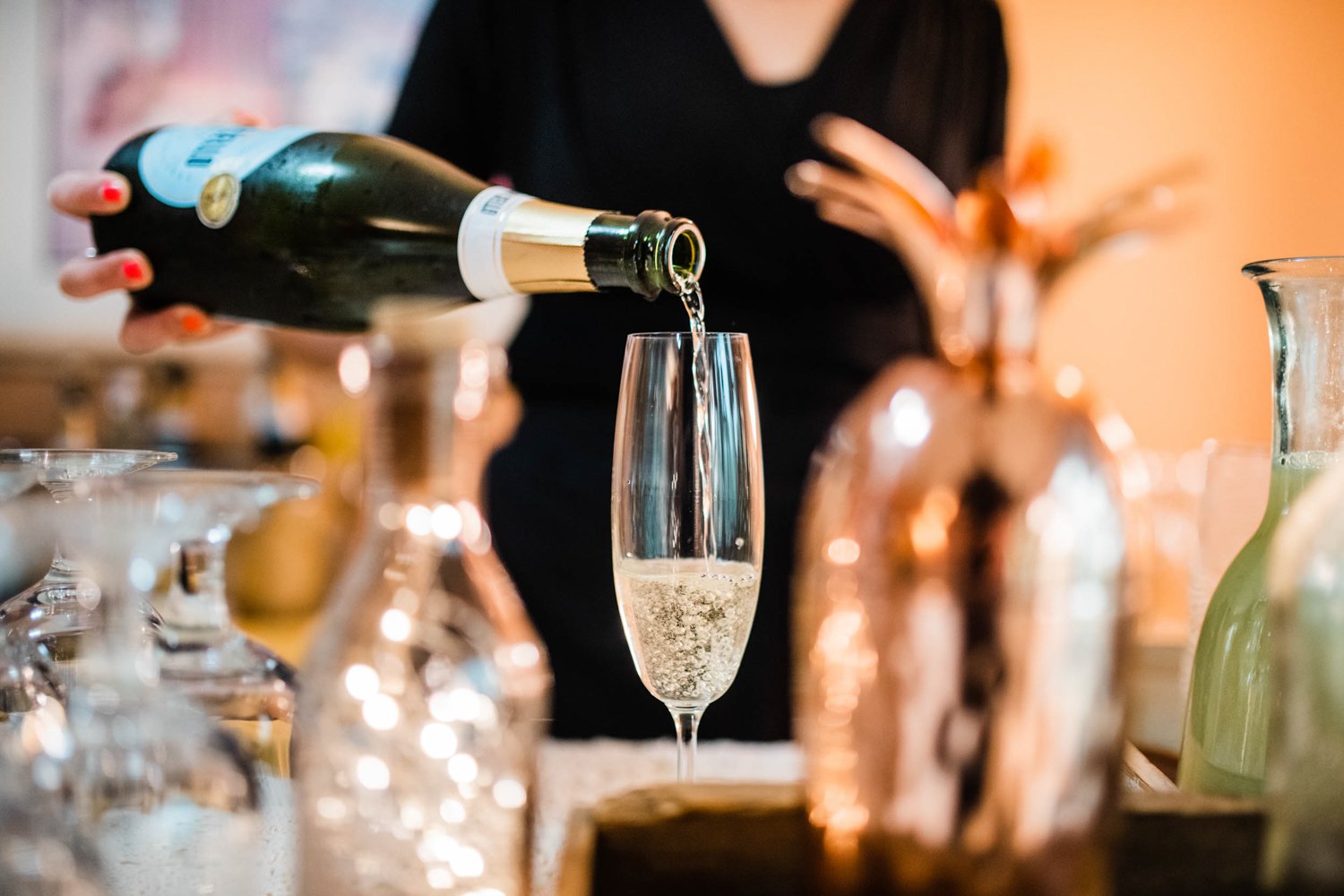 bartender pouring a glass of prosecco at wedding event