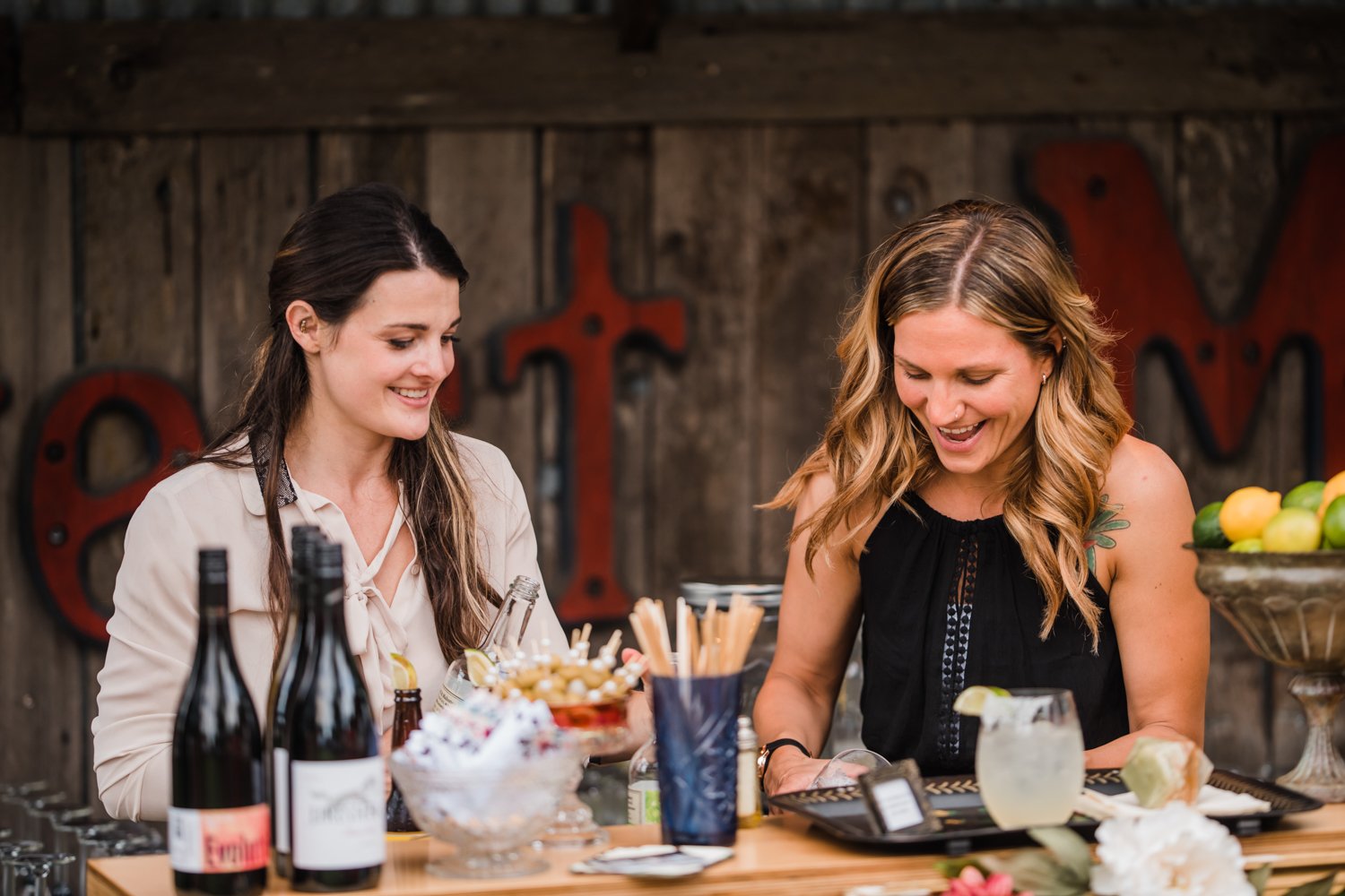 two women making craft cocktails during bar service at wedding in portland oregon