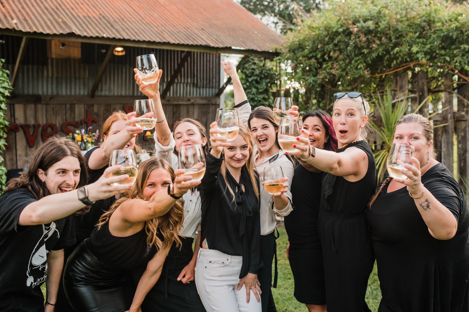 Art de Cuisine team women owned business cheers at outdoor garden wedding in portland oregon