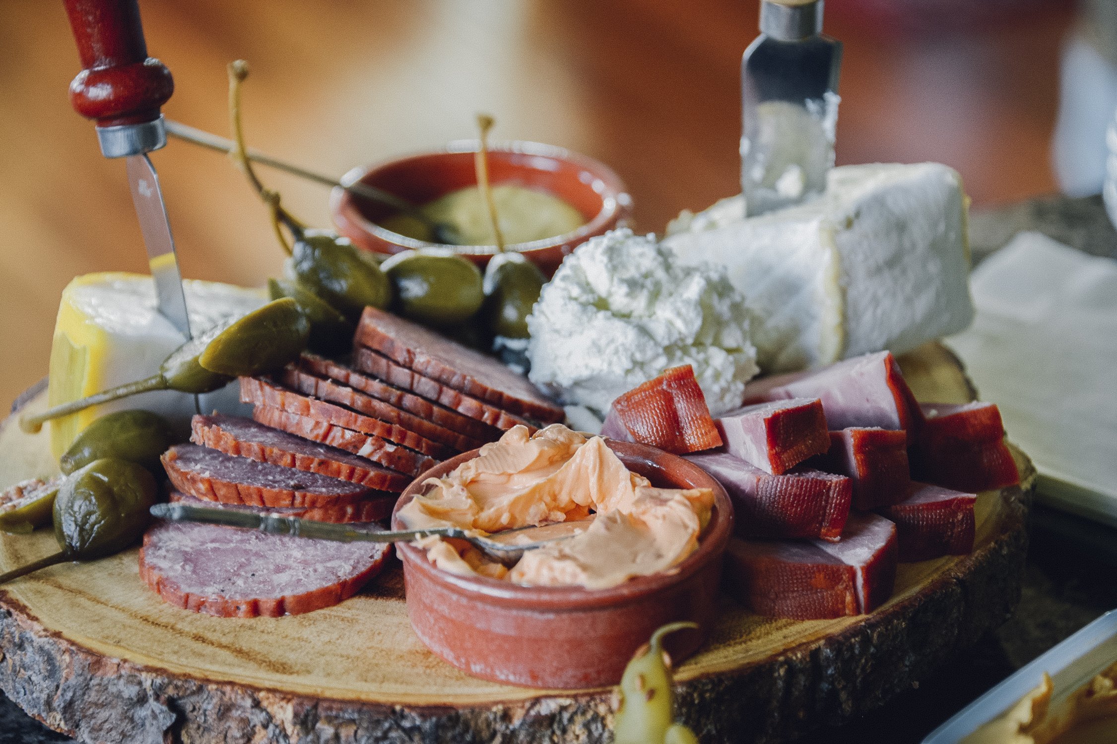 rustic cheese and charcuterie platter served on wood board