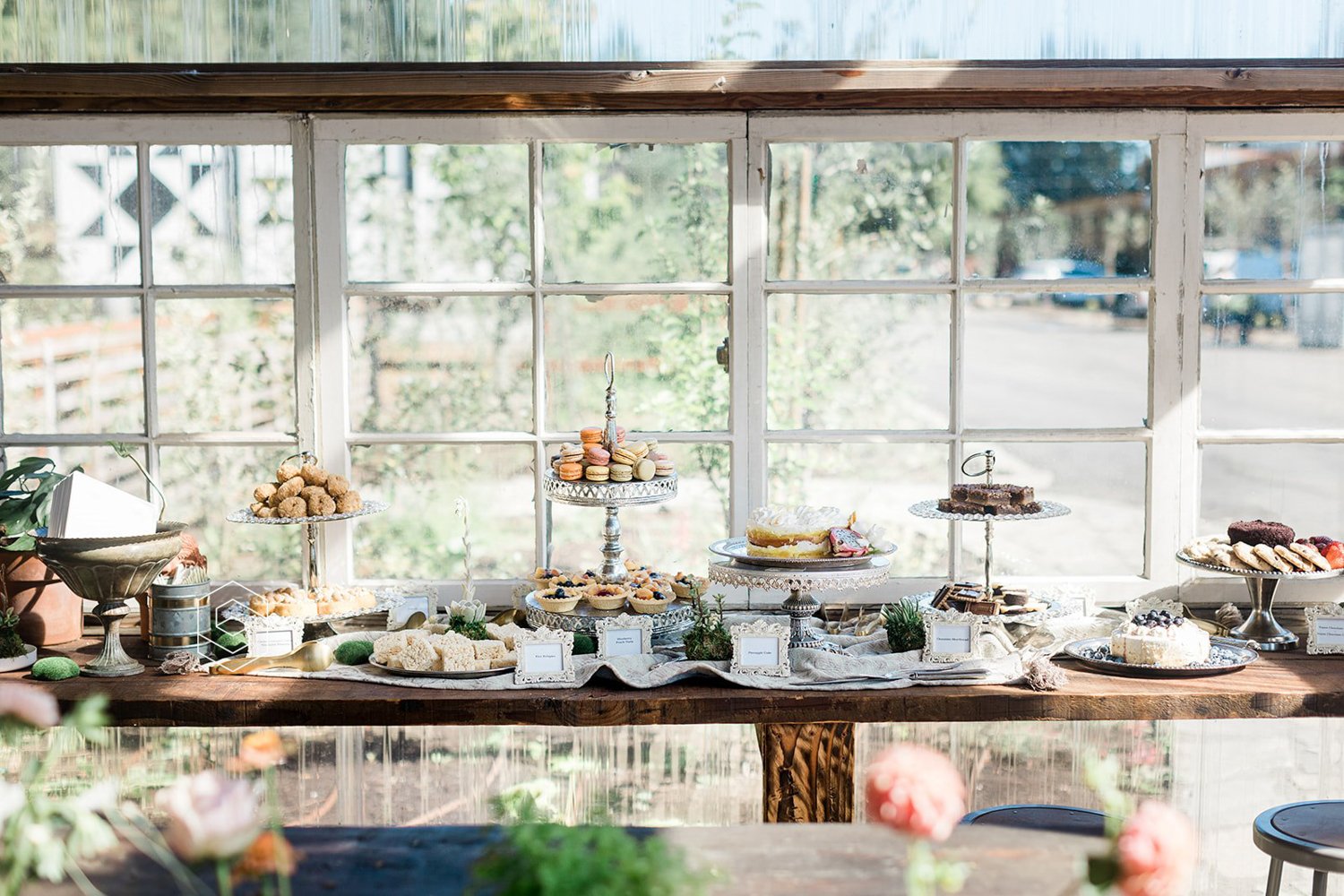 large dessert bar with macaroons cakes and pastries at wedding in portland oregon