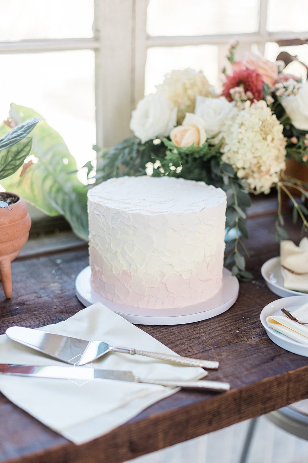 elegant simple white wedding cake with florals for wedding in portland oregon