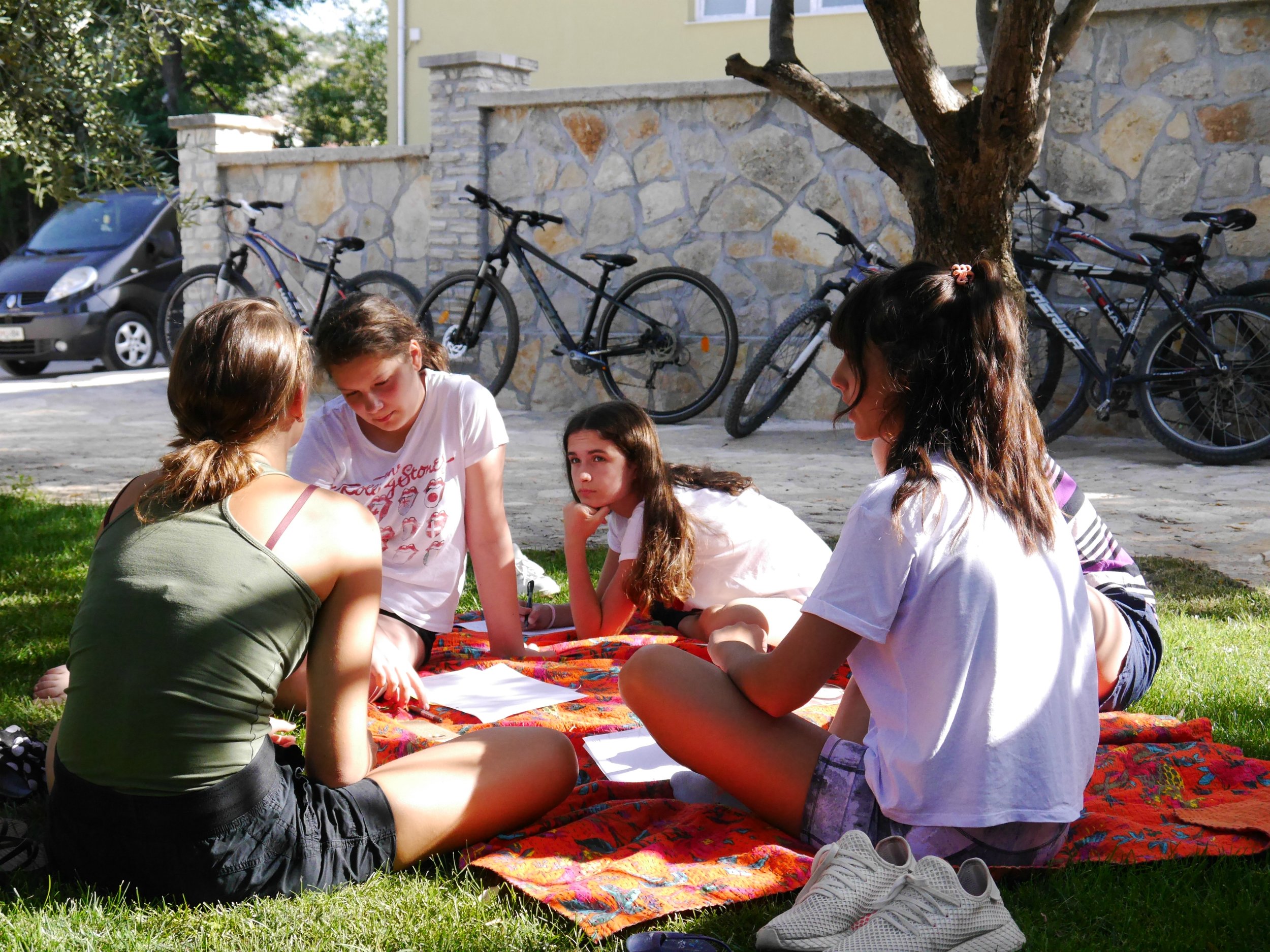 girls sitting on blanket .jpg