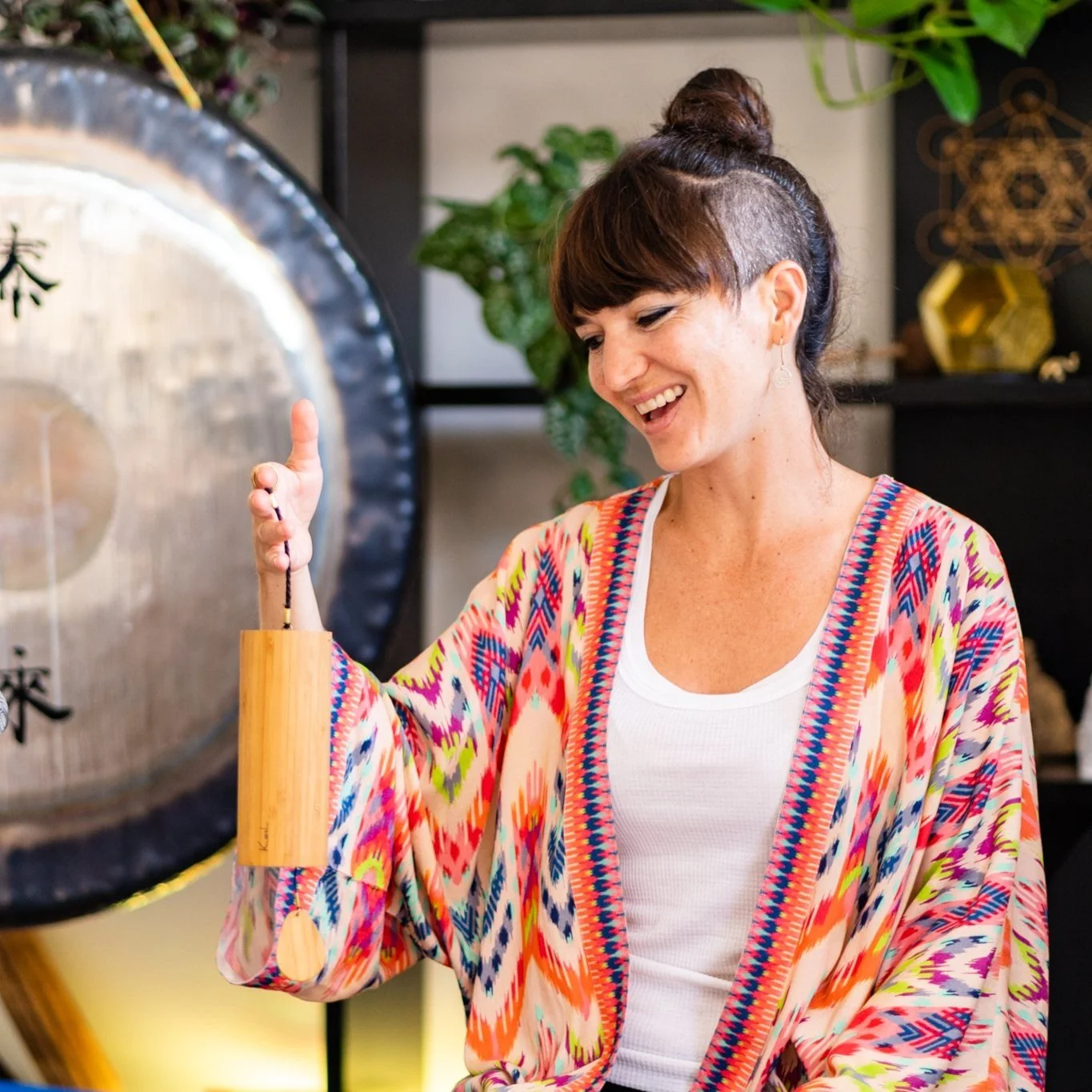 Woman in front of gong