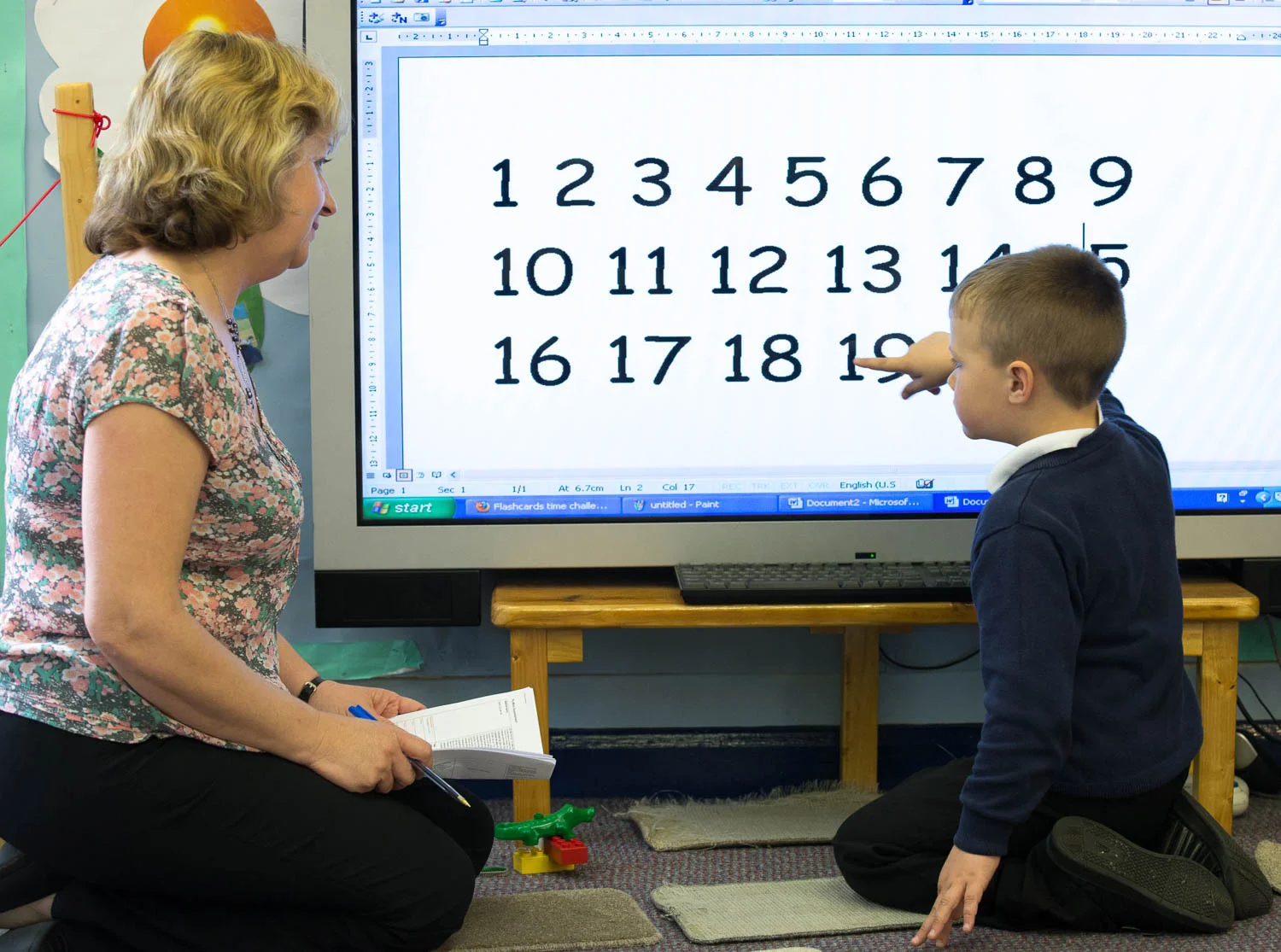 Teacher and child learning to count