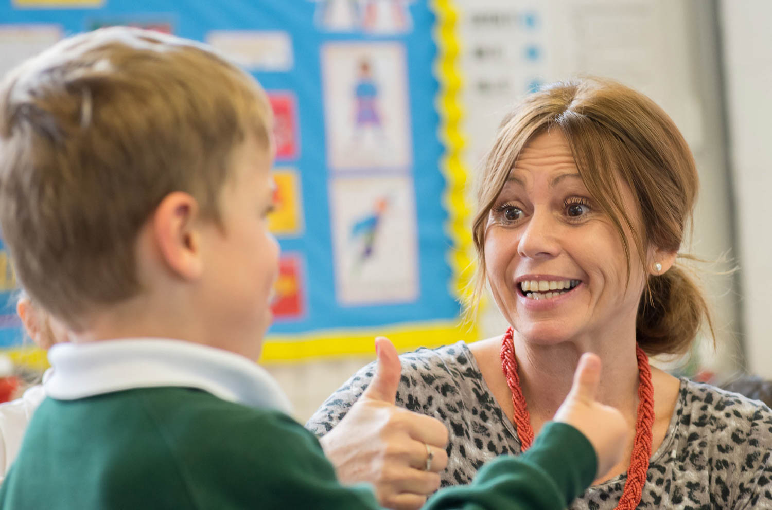 Teacher and school boy with thumbs up