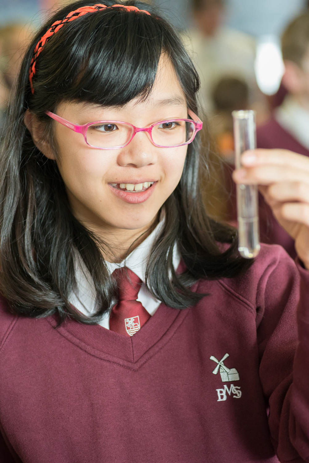 school girl holding test tube