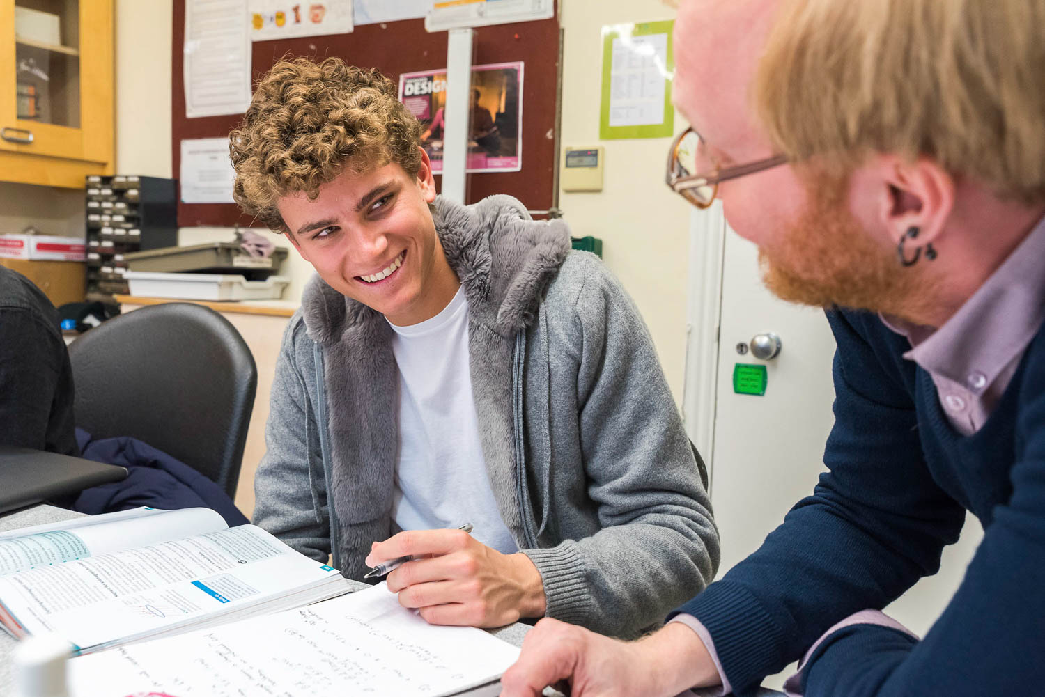 Student and teacher laughing