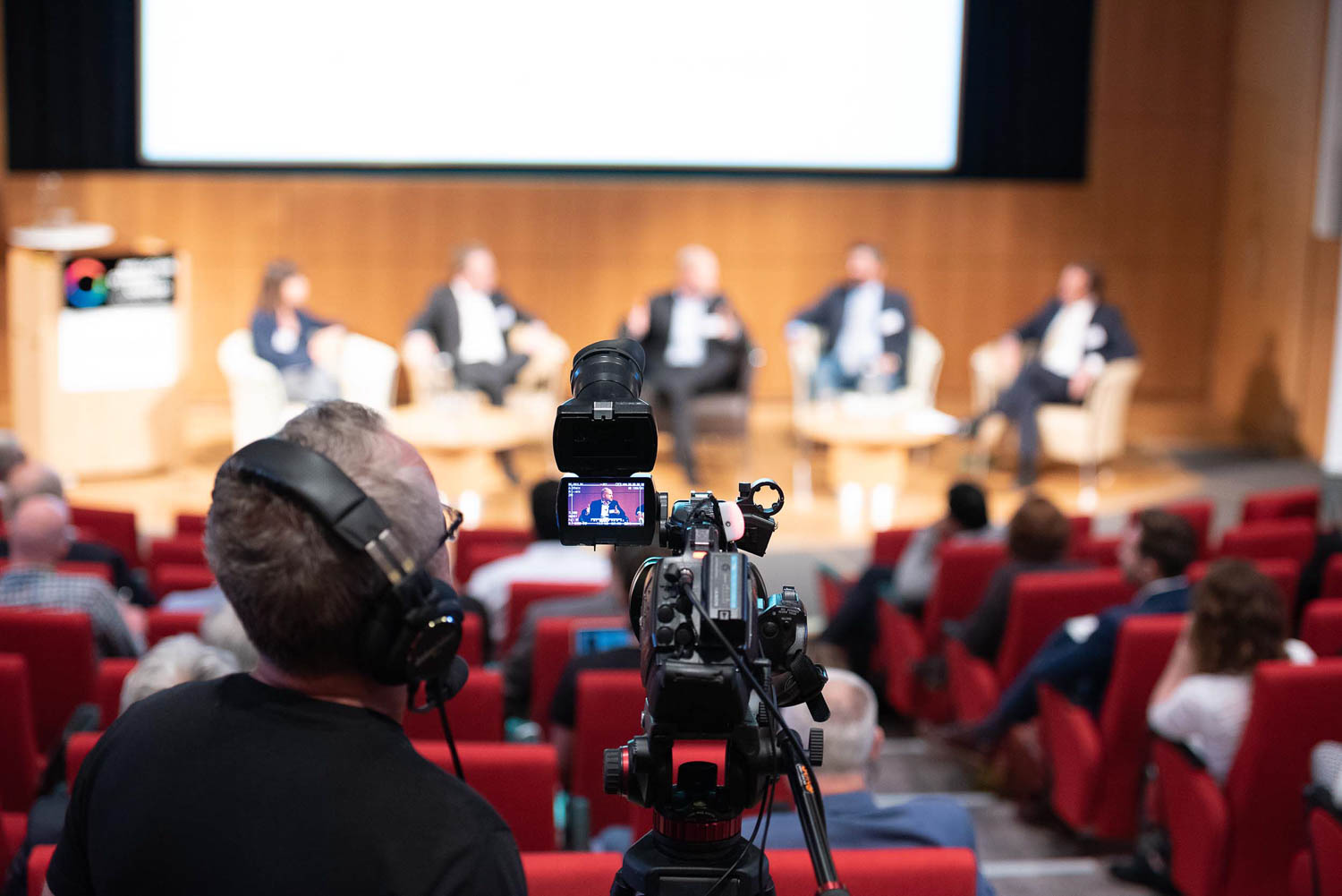 Conference panel discussion being videoed