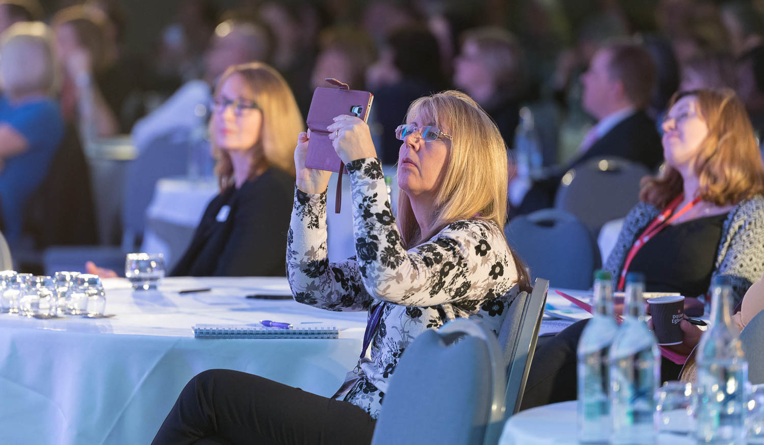 Delegate takes photo at conference