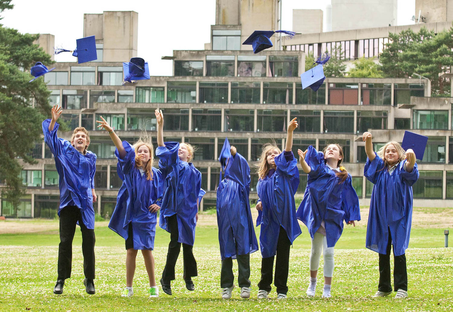 School children graduate and throw up their hats