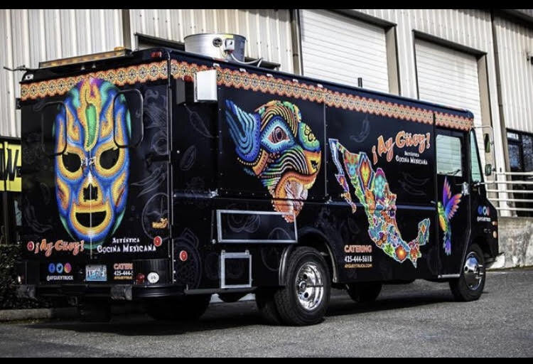  Photo:  Black food truck with bright colorful graphics. 