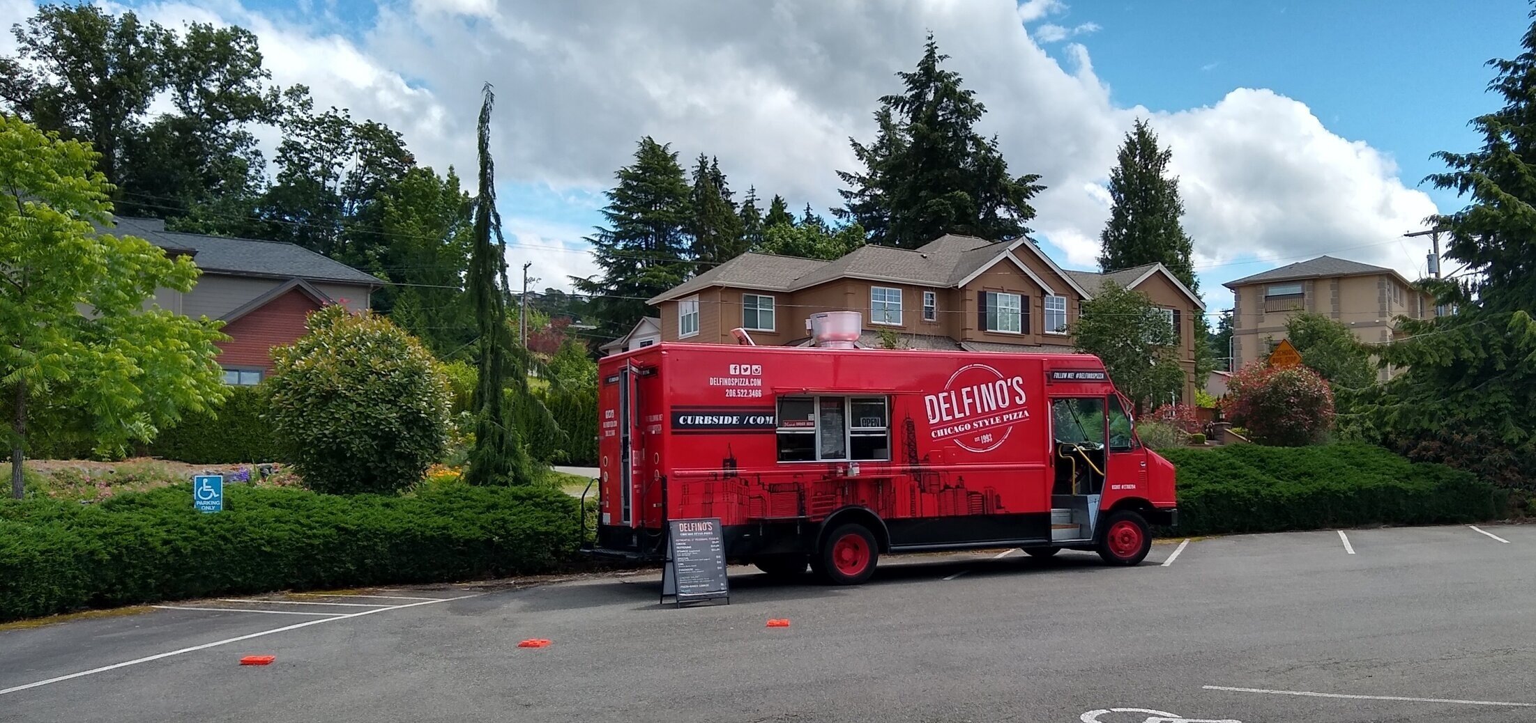 Photo:  Bright red food truck without any customers.  