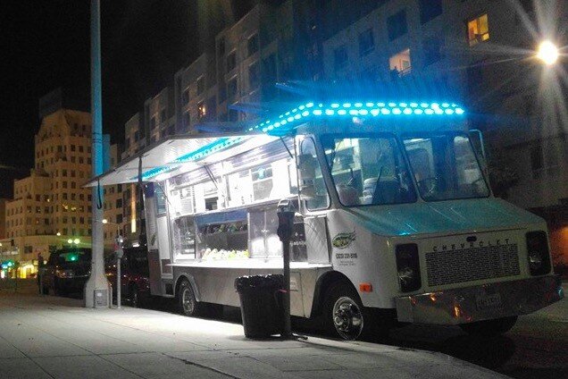  Photo:  Food truck at night with neon accent lighting.  