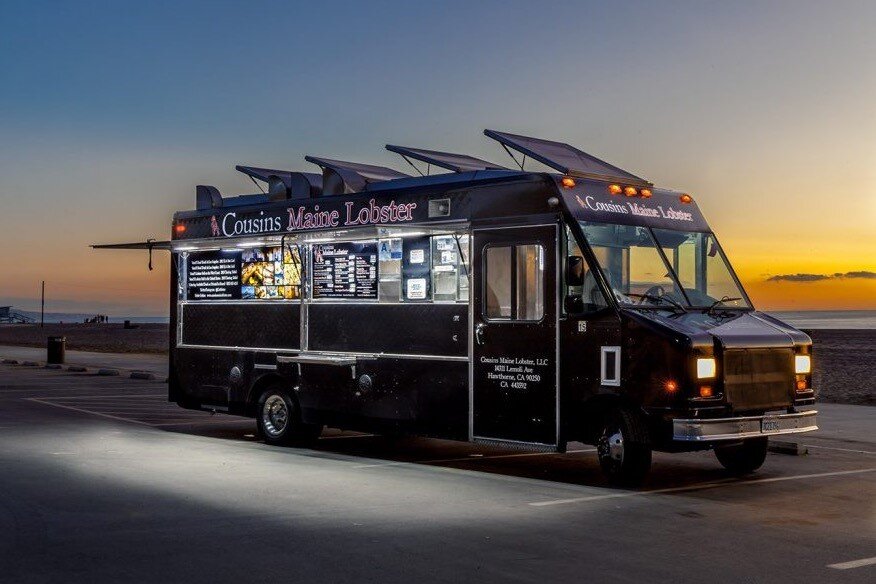  Photo:  Food truck at night with neon accent lighting.  
