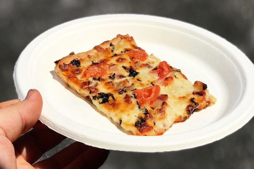  Photo:  Slightly out of focus photo of a slice of pizza.  It looks boring and unappealing.  