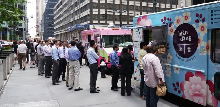  Photo: Hungry customers at a corporate location lined up in front of food trucks. 