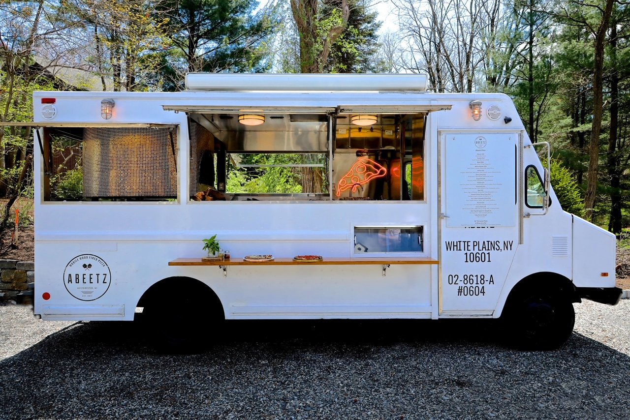  Photo:  A plain white food truck with almost no words or graphics.  