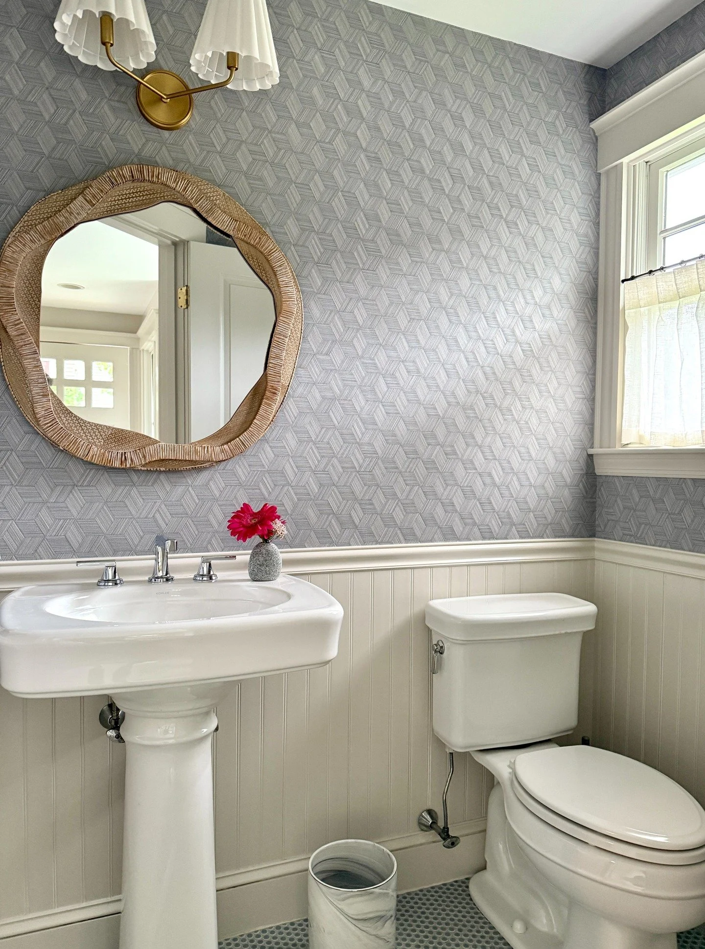 Small space, big impact ✨ This powder room design pairs textured wallpaper, a statement mirror, and chic brass lighting for timeless style with a playful twist. Perfect inspiration for your next small bathroom remodel or luxury powder room makeover ?