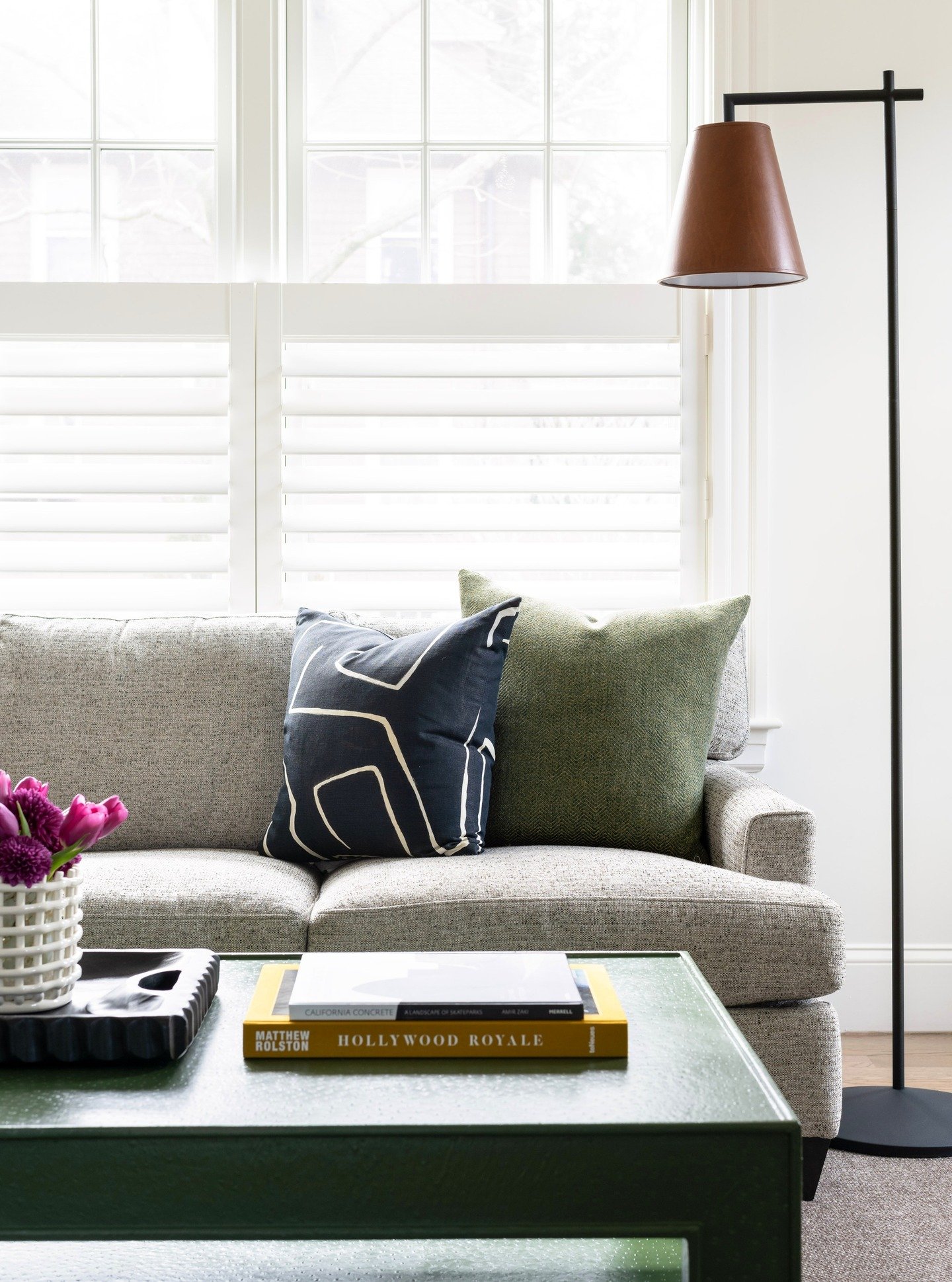 Sunlight, layered finishes, and timeless details from our Hemlock project. 

This cozy family room corner is all about balance&mdash;soft neutrals, tailored upholstery, modern lighting, and elevated everyday styling. Not fussy, but curated design for
